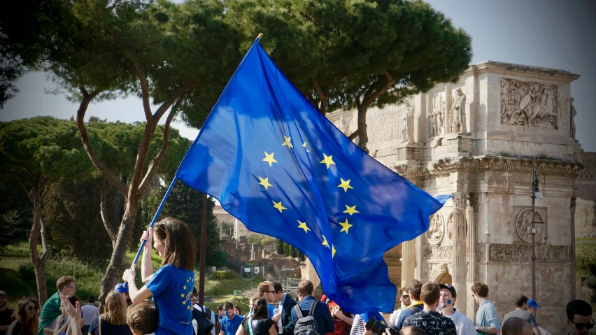 some people are holding flags near the gate