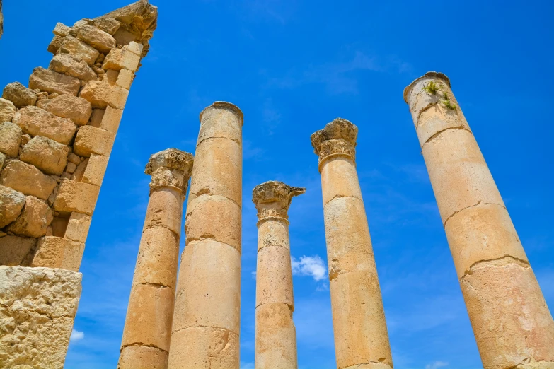 four ancient pillars under a bright blue sky