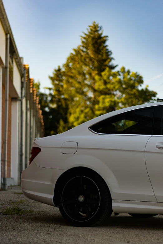 a white car is parked outside the building