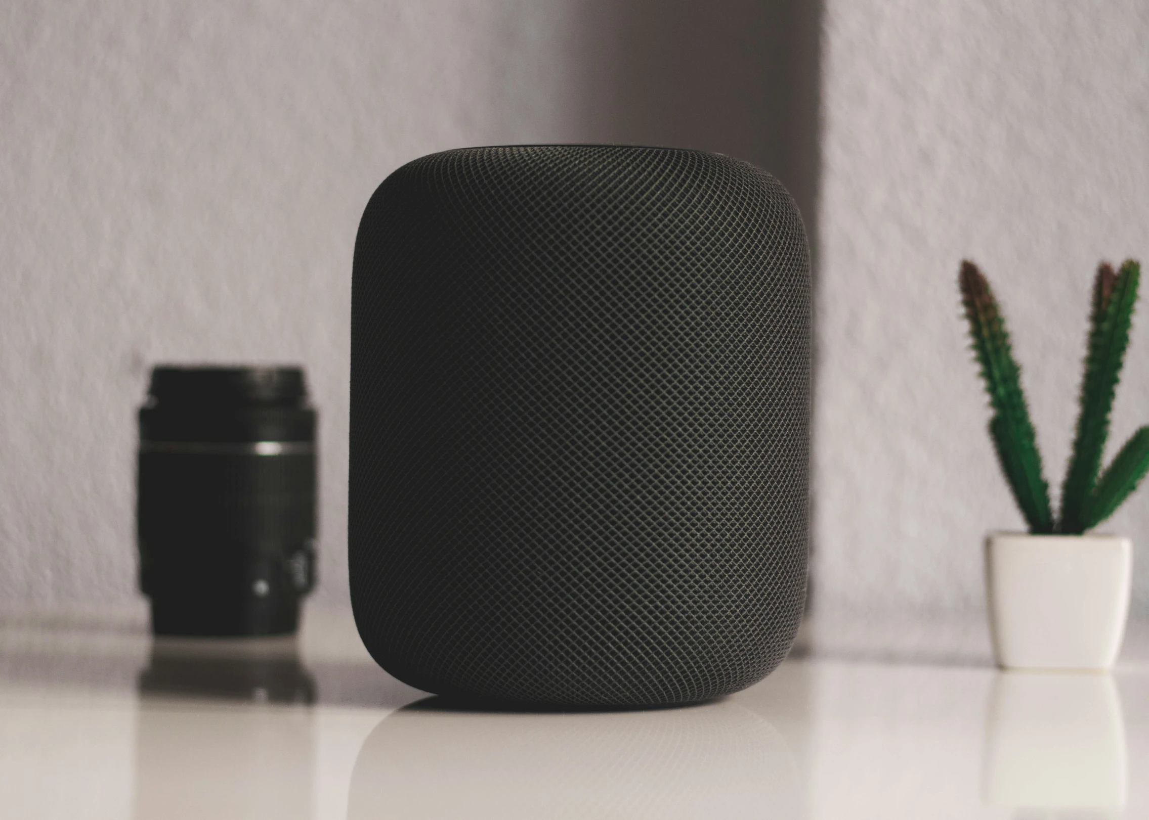 an apple home pod sits on a table