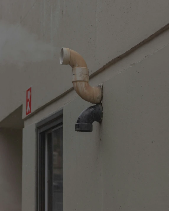 an old pipes spigot is sticking out from the side of a building