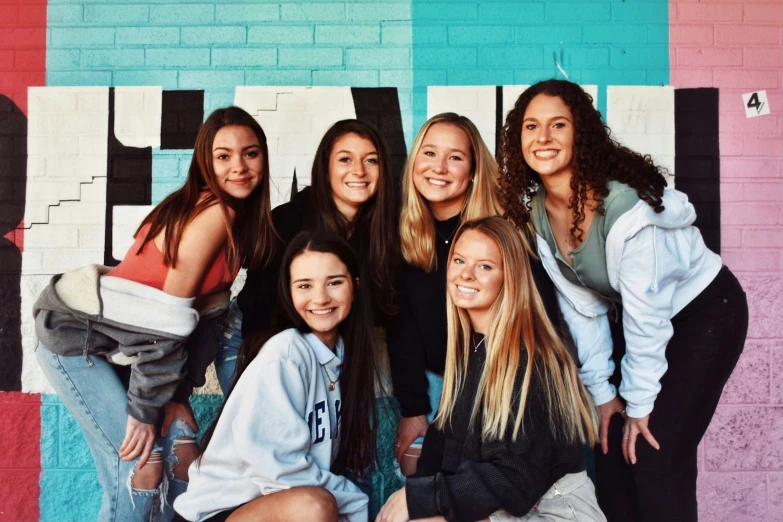 a group of girls pose together for a po