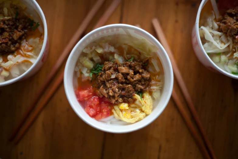 a couple bowls with various food in them