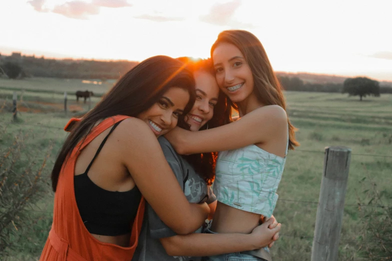 three friends hugging and having a good time