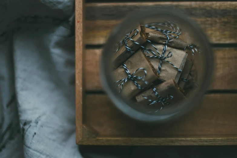 a glass container with lots of small wrapped boxes inside