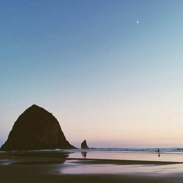 a mountain that is sitting on top of a beach