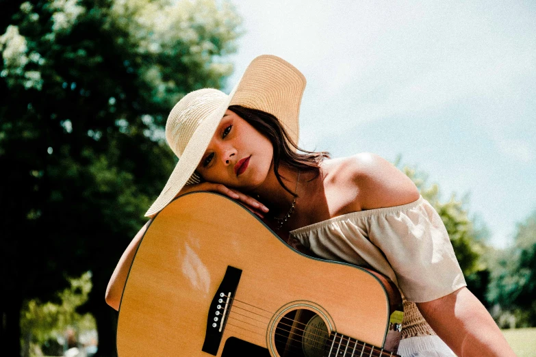 a girl in a hat and a hat with a guitar