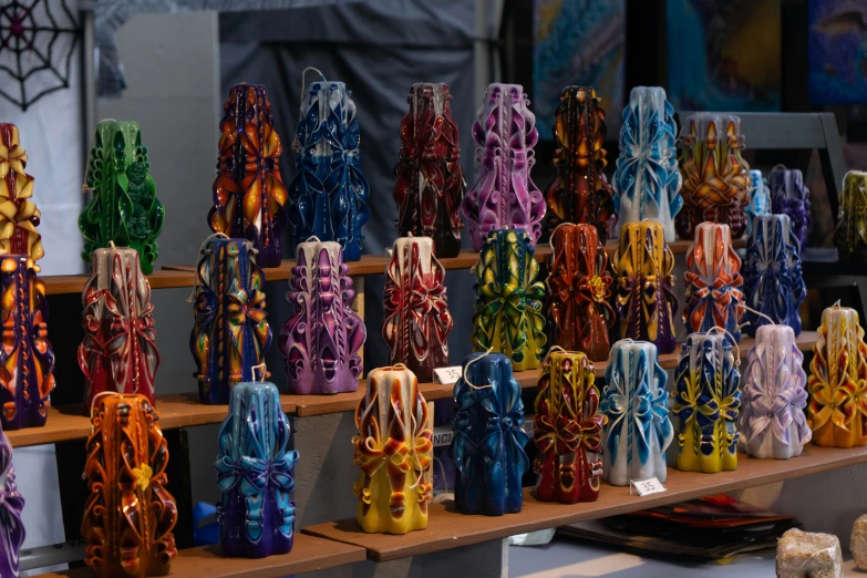 many different colored laces and bows on a shelf