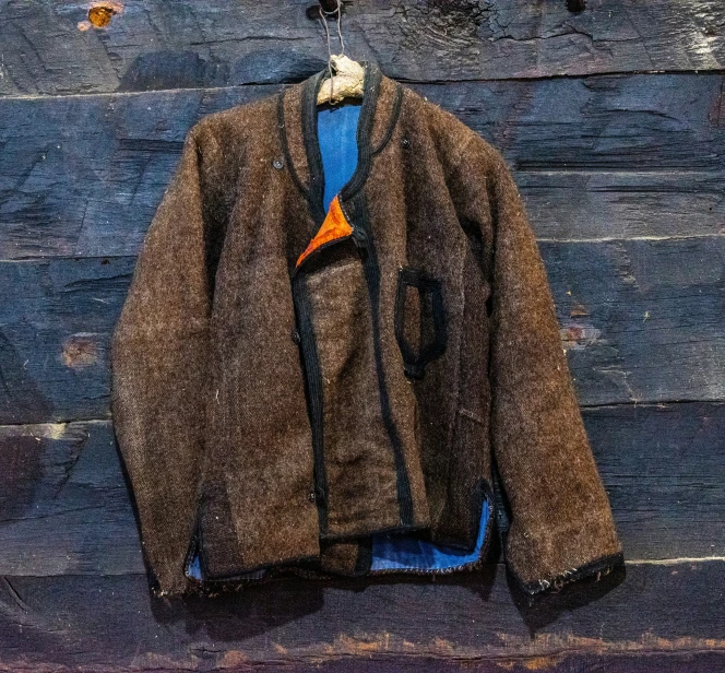 a brown jacket hanging on a clothes line