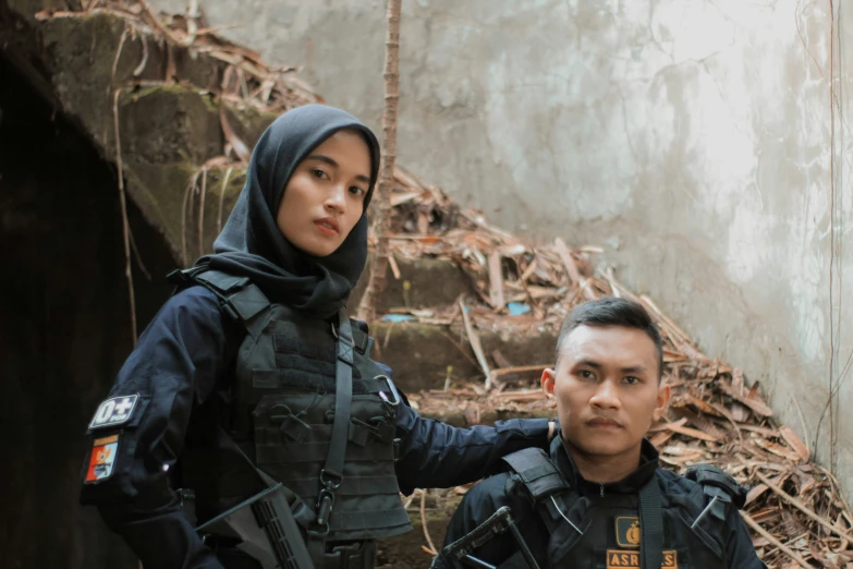 two people are standing in the dirt with their guns