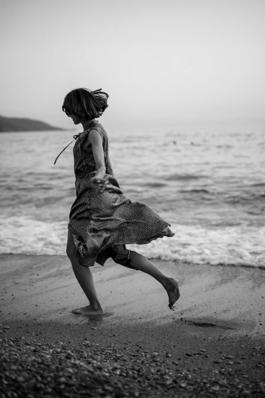 a black and white po of a  running at the beach