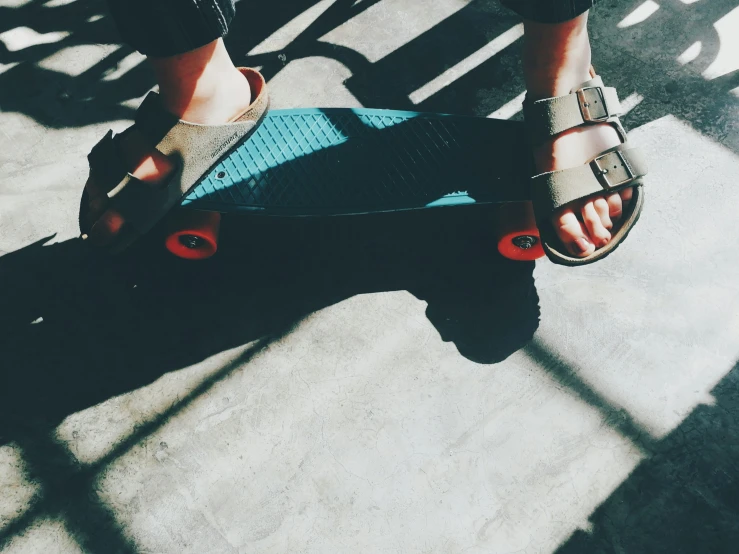 a person riding on a skateboard on a sidewalk