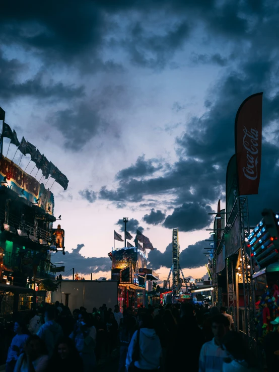 people are gathered at night in the middle of an open city