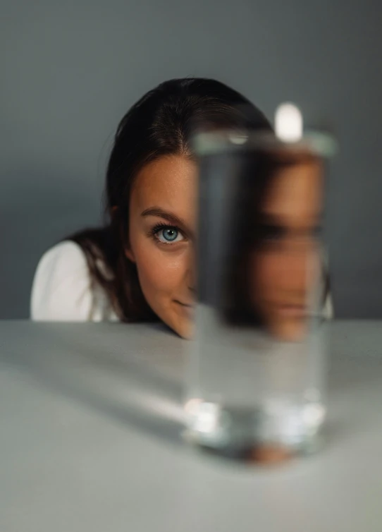 an image of a woman looking through the glass