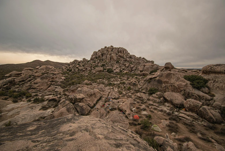 people standing on a mountain side in the distance