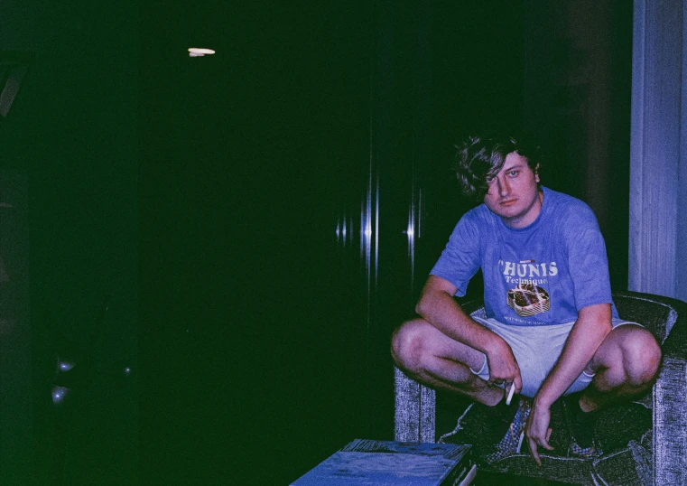 the young man is sitting on top of the dj equipment