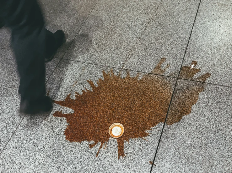 a light is reflected on the ground of a man walking