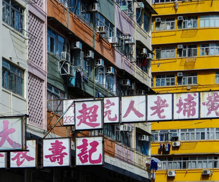 lots of signs with some buildings in the background