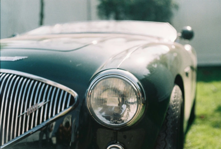 an old - fashioned car is parked in the grass