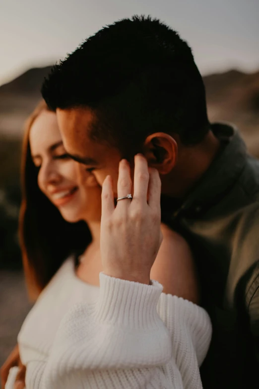 couple emcing close up together with hand under ear