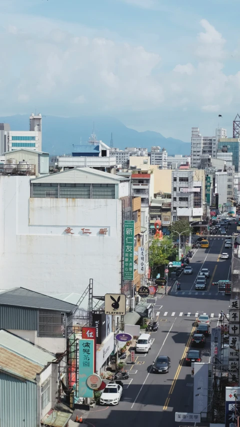 traffic drives down an urban street in japan