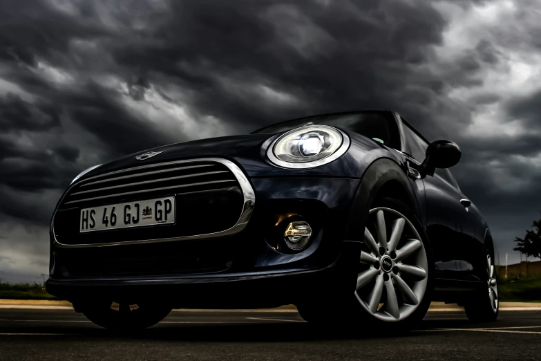 the car is on the road under some dark clouds