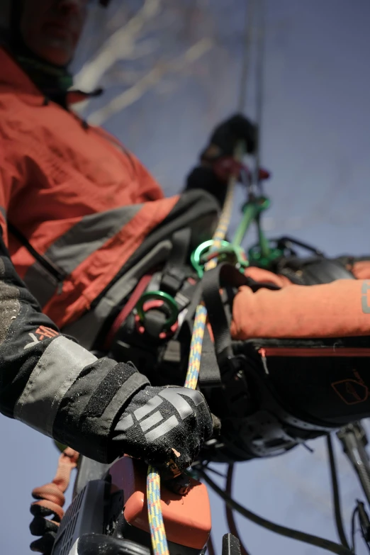 a person with a pair of gloves standing in front of a rope