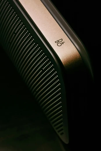 the side of a gold colored speaker that is shown