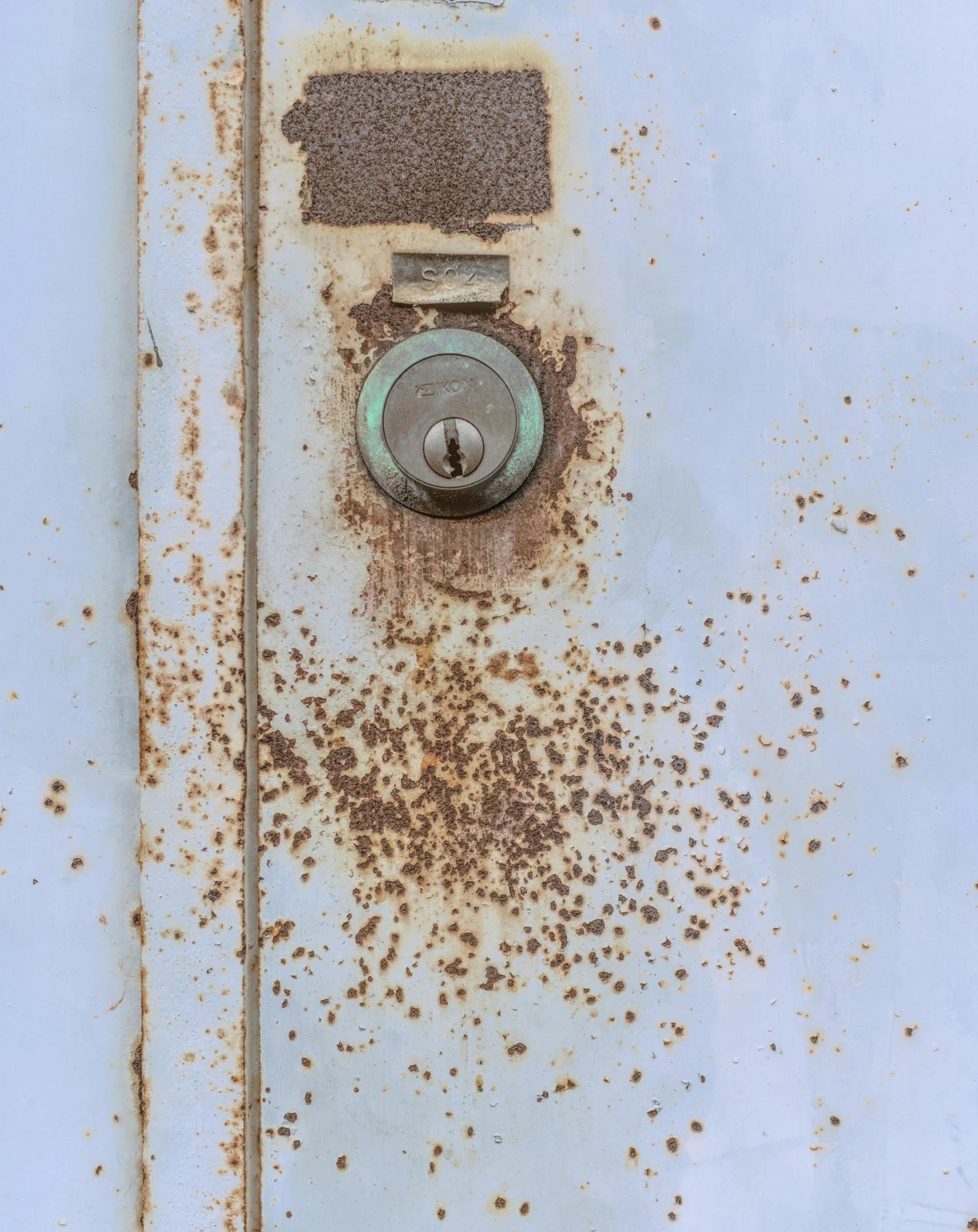 an industrial looking, rusted piece of metal with a hole in the middle