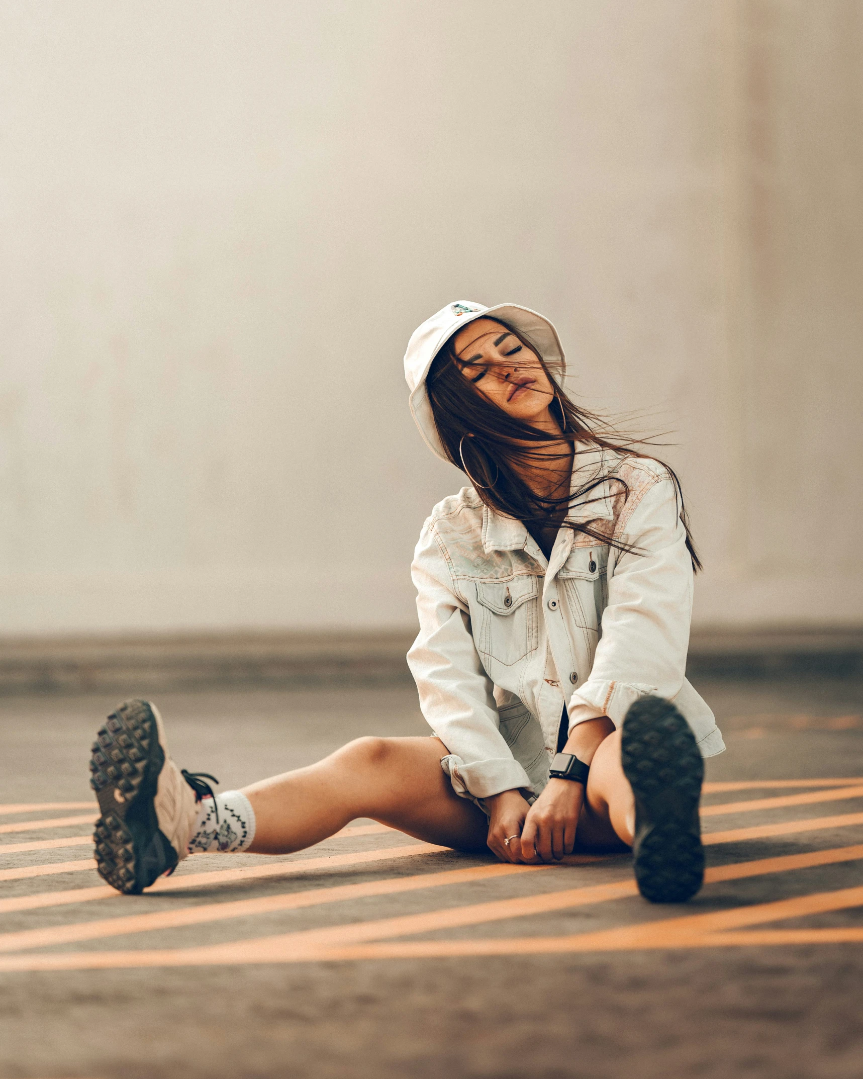 a young woman sits down while laughing