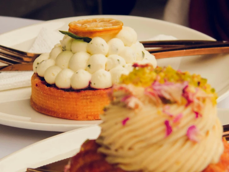 a plate with pastry on a table with fork and knife