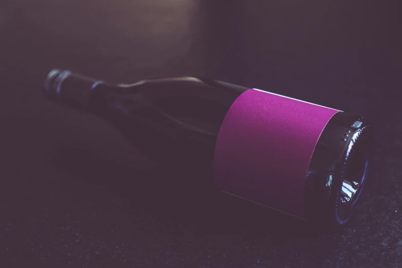 the wine bottle is partially submerged by a purple band