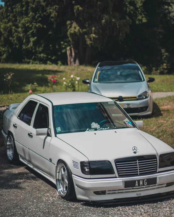 a white car parked in the driveway by a road