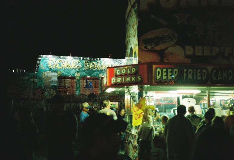 there are people standing outside the street food stand