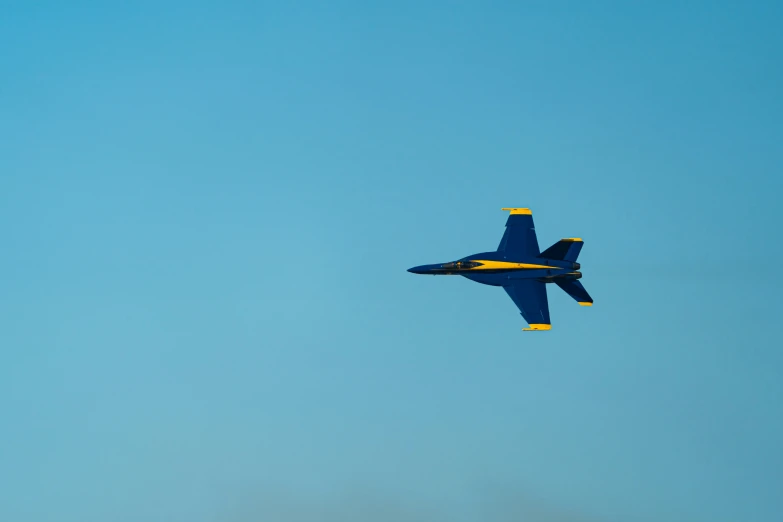 a fighter jet flying in the sky over some buildings