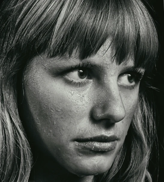 a black and white po of a woman with freckles