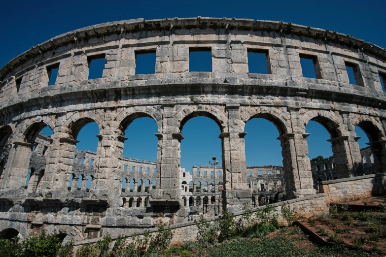 an old stone structure with three windows at the top of it