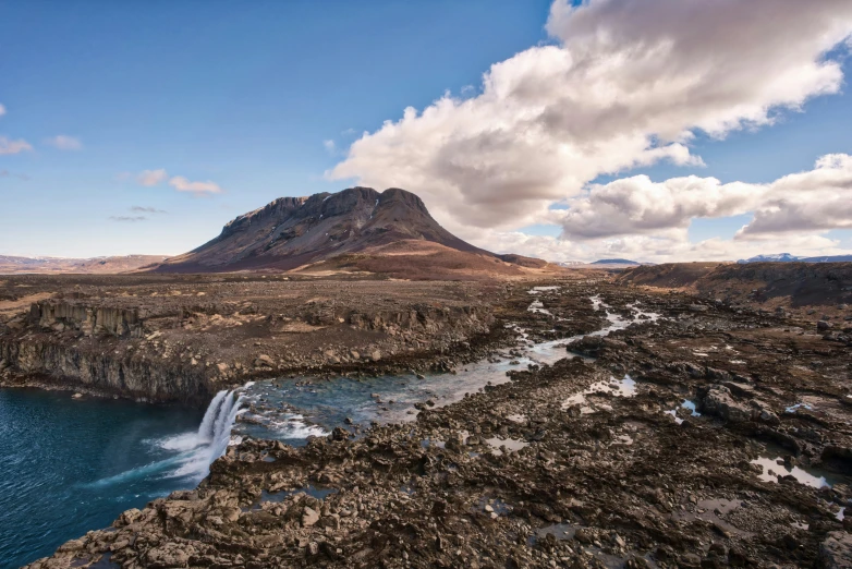 the water is flowing from a dam into the land