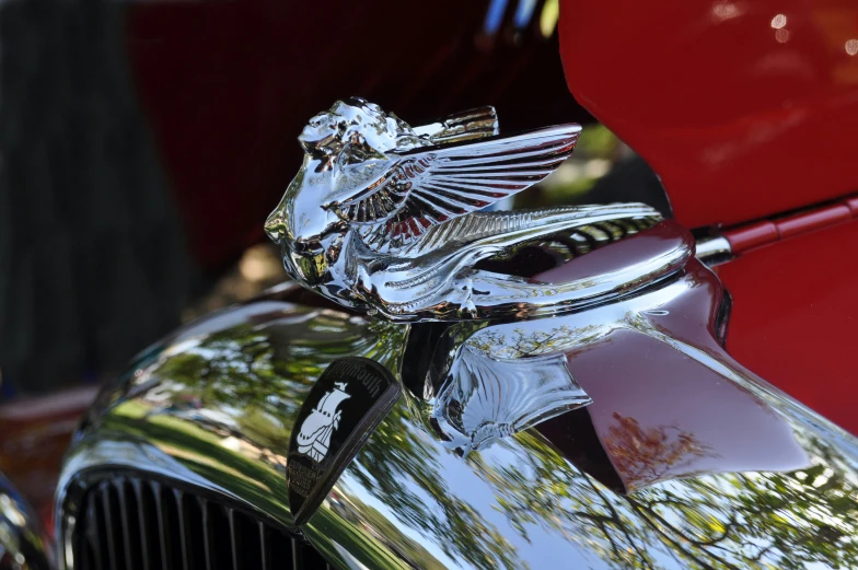 the emblem on a classic car with its hood scoop up