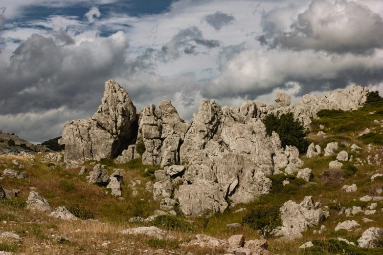 a horse grazing in a pasture on a rocky landscape