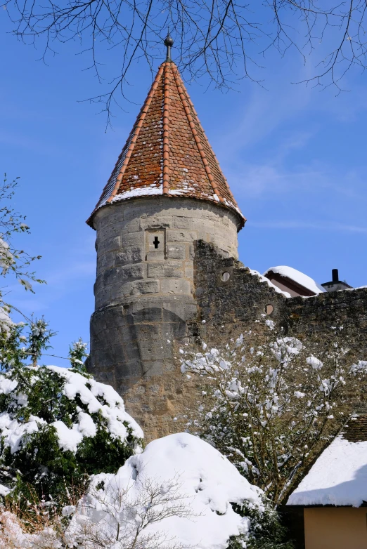 a view of an old castle tower in the snow