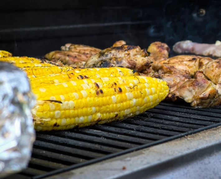 there is an bbq with corn on the cob