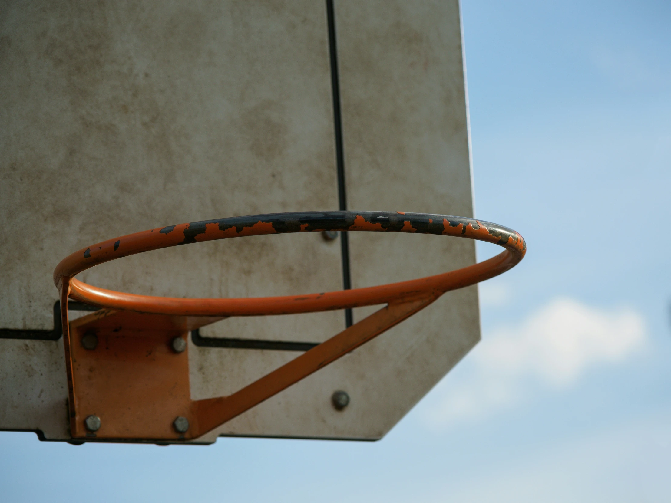 the top part of a basketball court with the sky in the background