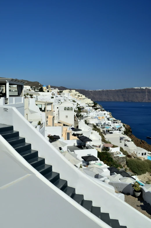 many buildings sit on the hillside next to water