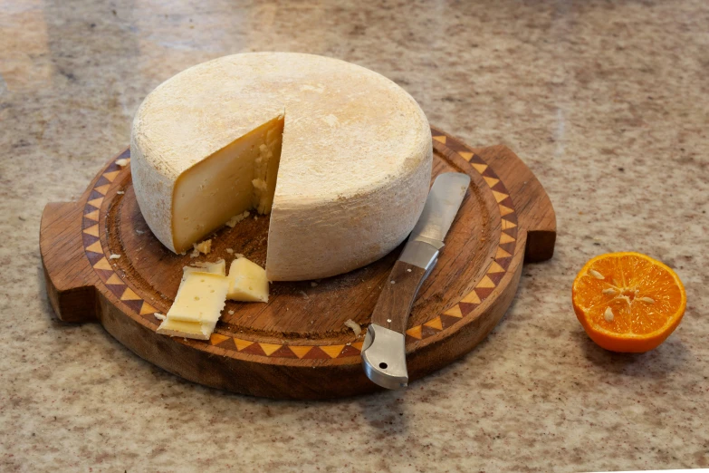 a knife and slice of cheese that has been cut into