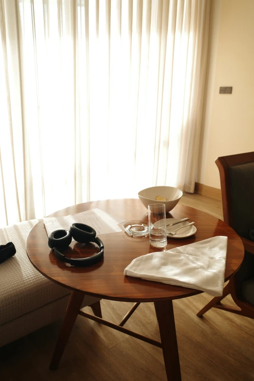 a round table with bowls and two plates on it