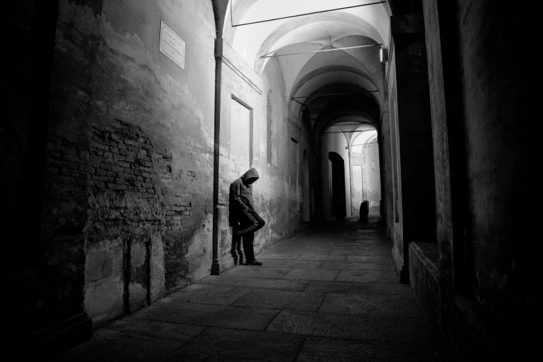 person standing in doorway to a building while looking down