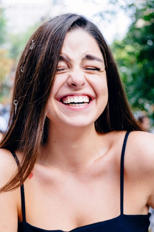 a girl wearing a black shirt is laughing