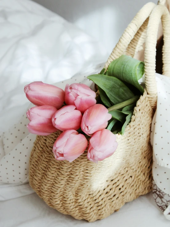 a basket of flowers on a bed