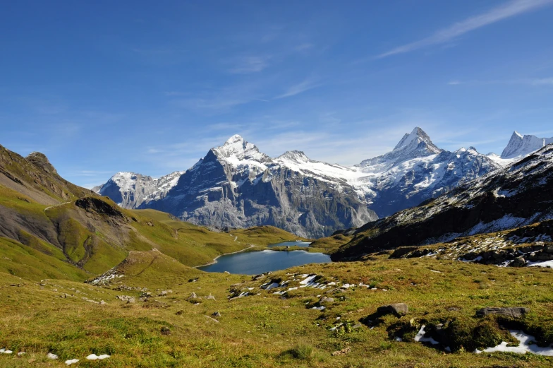 a large mountain valley has a lake in the middle of it